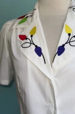 Holiday Lights Button Down Blouse In White 6 Holiday Lights Button Down Blouse In White -MODERN MILLIE Shop 14E0461F 3344 4067 B7FA 78D23DD33050