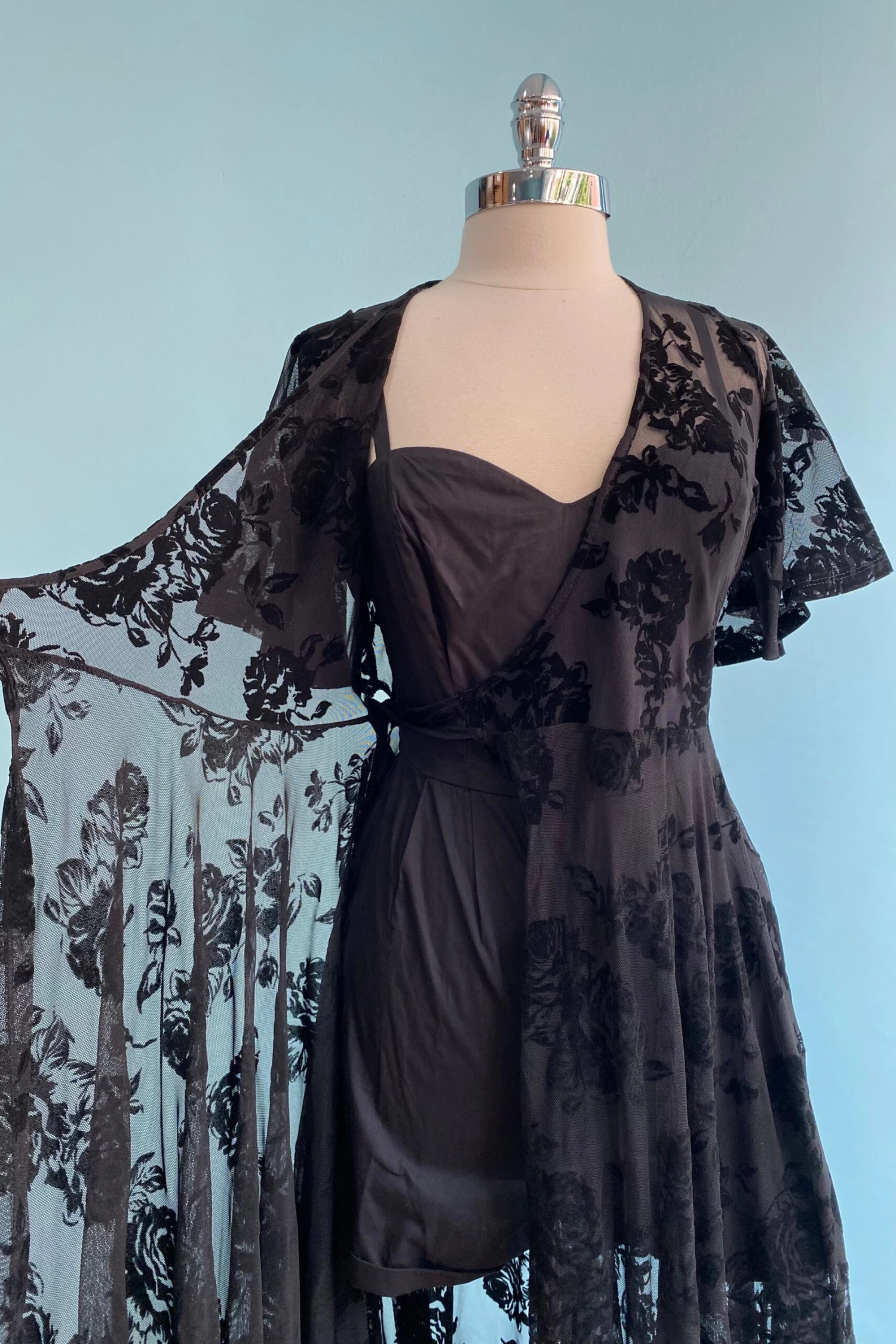 Lydia Wrap Dress in Black Flocked Rose Mesh by Wax Poetic Lydia Wrap Dress In Black Flocked Rose Mesh By Wax Poetic -MODERN MILLIE Shop image 1307571d 2d2a 4fa1 b6bd a500c76e84d2 scaled